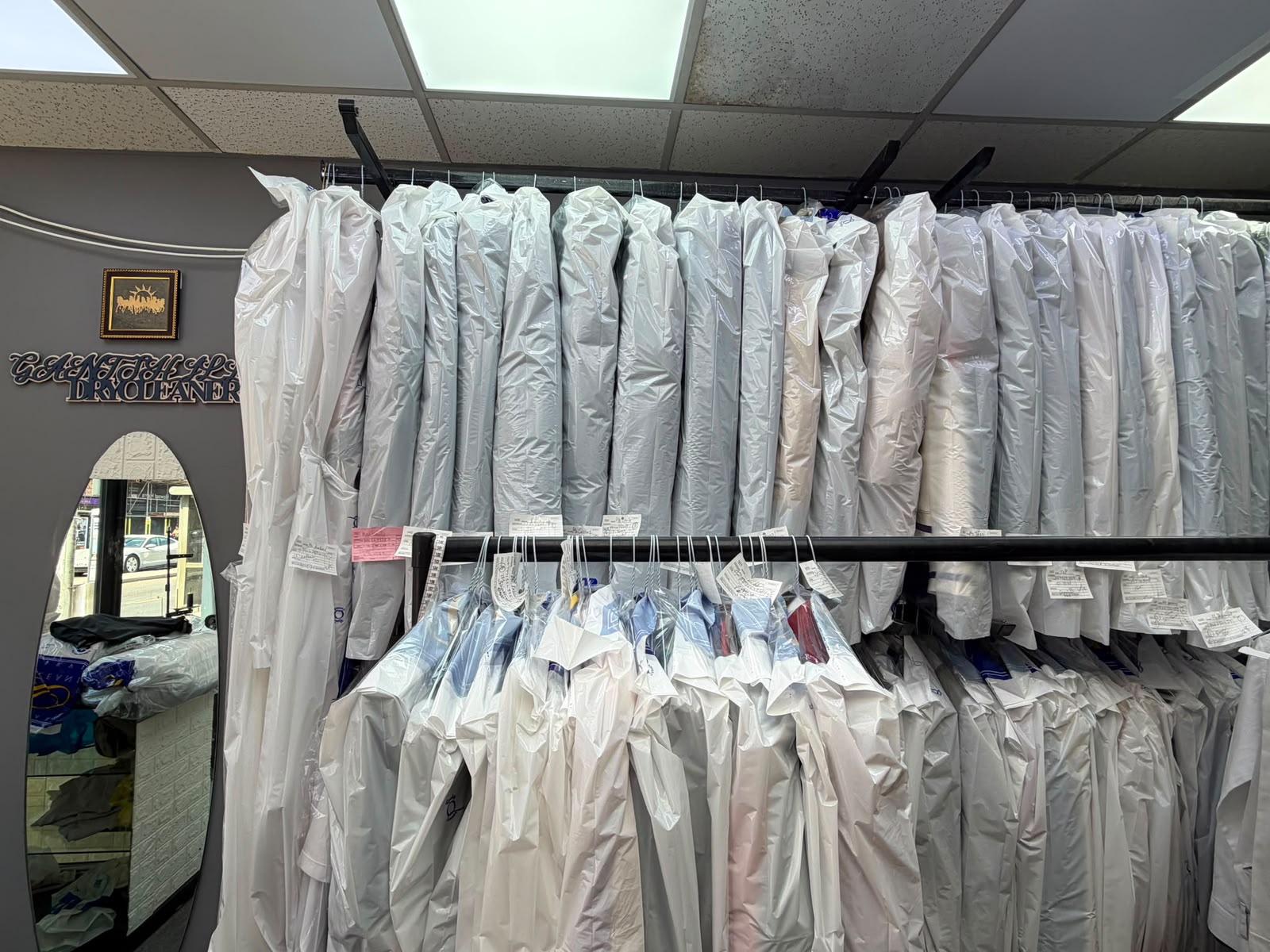 Cleaned garments prepared for customers inside Gants Hill Dry Cleaners